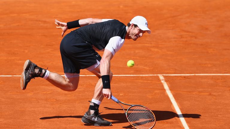 Andy Murray of Great Britain stretches to return during his semi-final match against Rafael Nadal of Spain