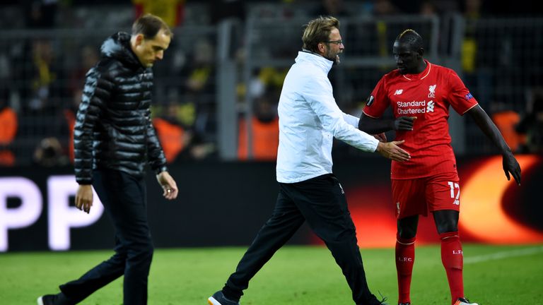 Jurgen Klopp with Mamadou Sakho as Thomas Tuchel looks dejected after the Europa League quarter final first leg between Borussia Dortmund and Liverpool