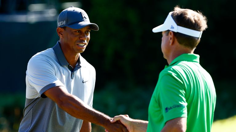 Tiger Woods and Davis Love III of the United States shake hands