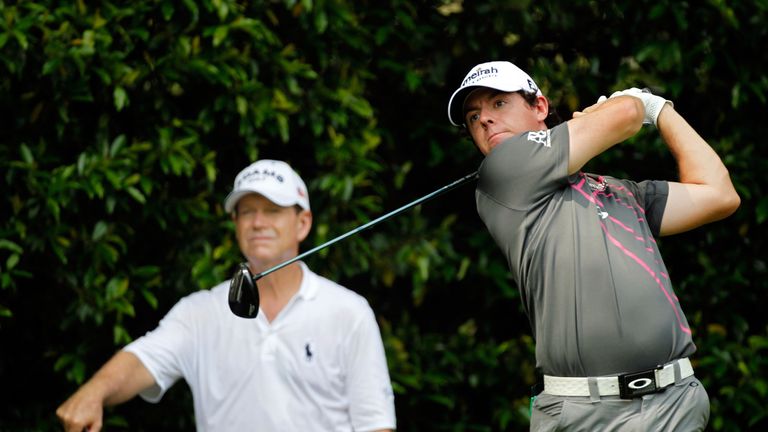 Tom Watson (L) watches  Rory McIlroy (R) tee off during a practice round ahead of the 2012 Masters