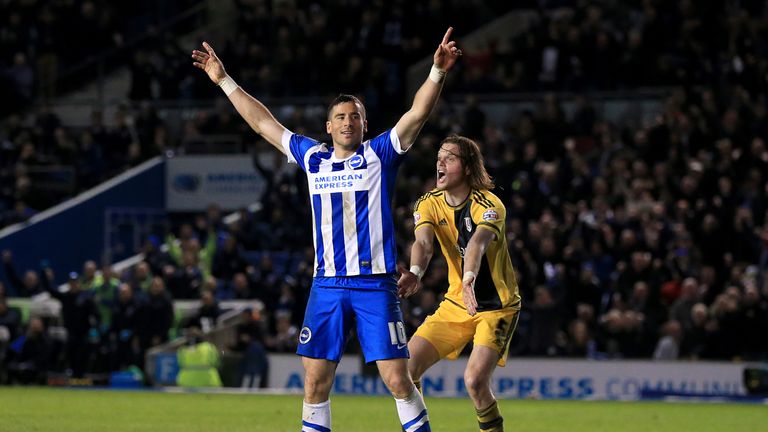 Brighton and Hove Albion's Tomer Hemed celebrates scoring his side's fourth goal of the game, and completes his hat-trick, as Fulham's Richard Stearman (ri
