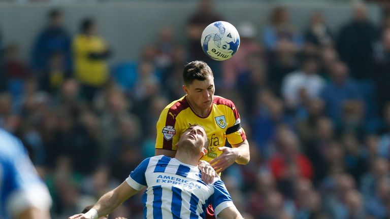 Burnley's Michael Keane and Brighton and Hove Albion's Tomer Hemed battle for the ball