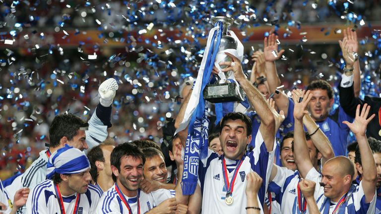 LISBON, PORTUGAL - JULY 4:  Traianos Dellas of Greece lifts the trophy during the UEFA Euro 2004 Final match 