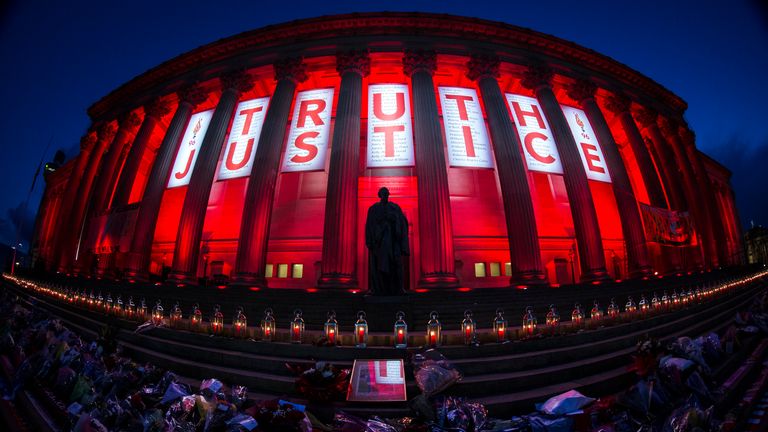 A banner reading Truth and Justice is hung from Liverpool's St George's Hall and illuminated in red after a vigil for the 96 Hillsborough victims