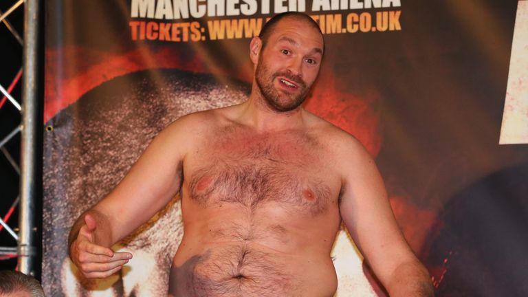 Tyson Fury speaks after removing his shirt