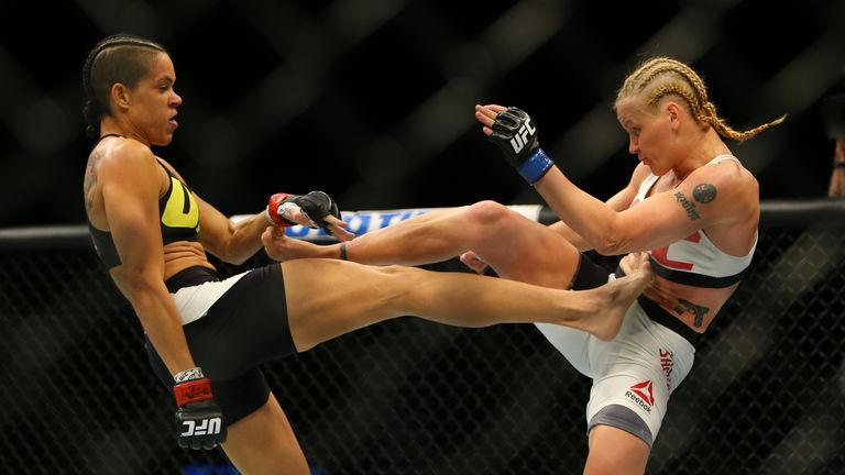 Amanda Nunes (L) kicks Valentina Shevchenko during UFC 196 