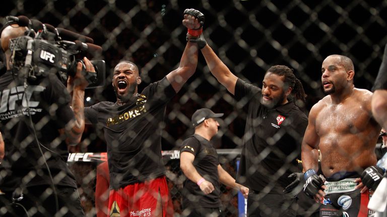 Jon Jones (L) celebrates after defeating Daniel Comier (R) during their light heavyweight title fight 