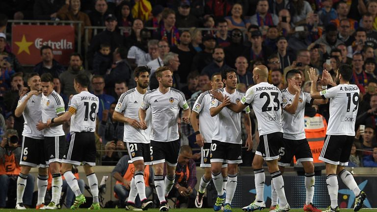 Valencia celebrate after scoring the opening goal at the Camp Nou