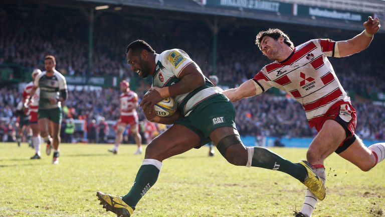 Vereniki Goneva of Leicester breaks clear of James Hook to score a second half try during the Premiership match between Leicester Tigers and Gloucester