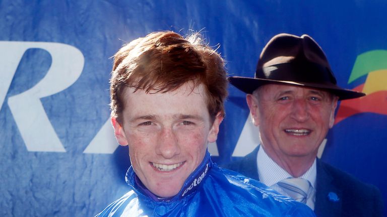 Jockey Sam Twiston-Davies with the Scottish Grand National trophy after riding Vicente to victory