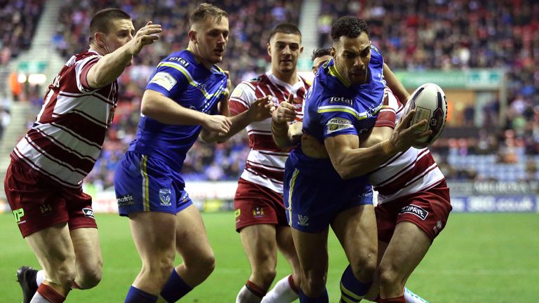 Warrington Wolves' Ryan Atkins drives to the line to score a try