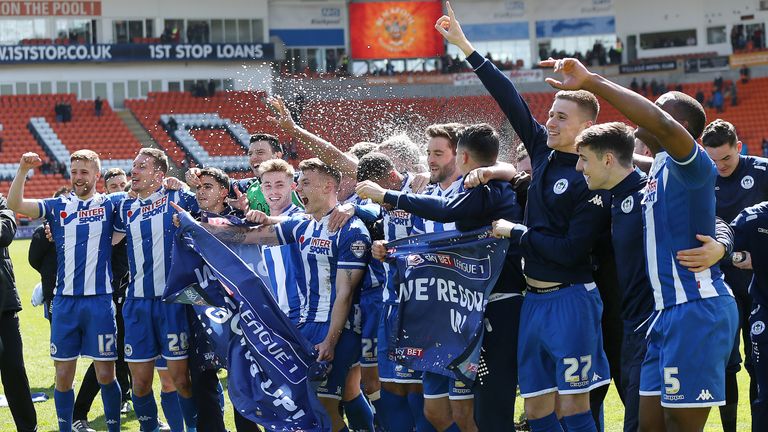 Wigan Athletic players celebrate winning promotion to the Sky Bet Championship 