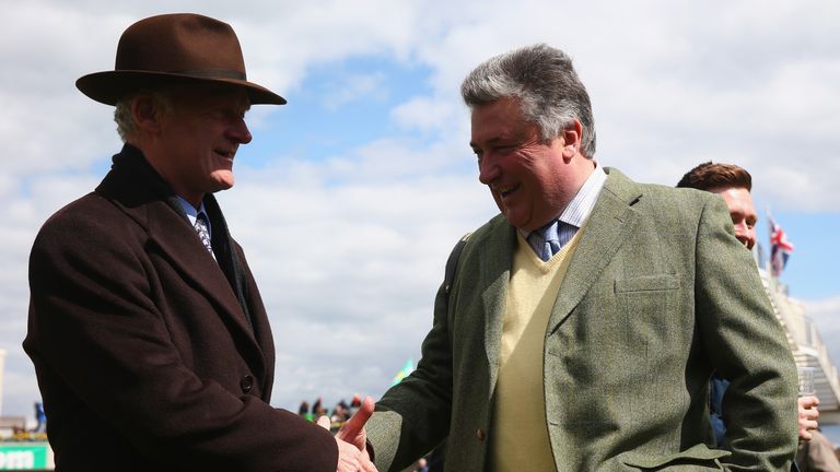 ESHER, ENGLAND - APRIL 23: Trainers Willie Mullins (L) shakes hands with Paul Nicholls ahead of the first race at Sandown Park on April 23, 2016 in Esher, 