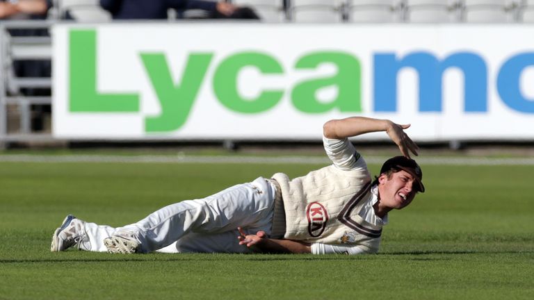 MANCHESTER, ENGLAND - SEPTEMBER 15:  Zafar Ansari of Surrey waves for attention as he injures his hand fielding during day two of the LV County Championshi