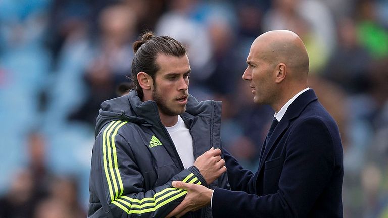 GETAFE, SPAIN - APRIL 16: Gareth Bale (L) of Real Madrid CF clashes hands with his head coach Zinedine Zidane (R) as he leaves the pithc  during the La Lig
