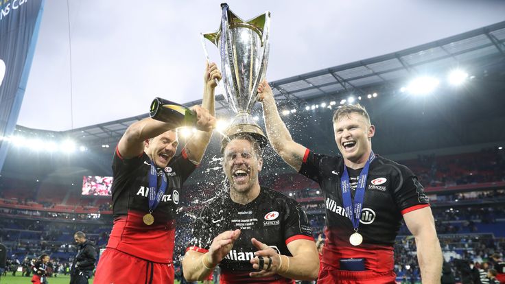 Alex Goode (l), Chris Wyles (c) and Chris Ashton (r) of Saracens celebrate with the Champions Cup trophy