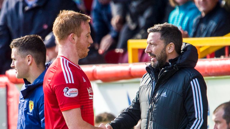 Aberdeen striker Adam Rooney  (left) is congratulated by his manager Derek McInnes as he leaves the pitch during the game against Motherwell