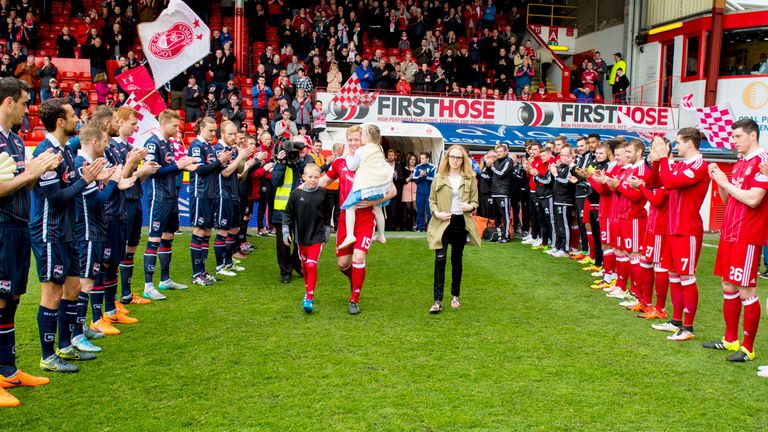 Aberdeen and Ross County players give a guard of honour for Dons captain Barry Robson.