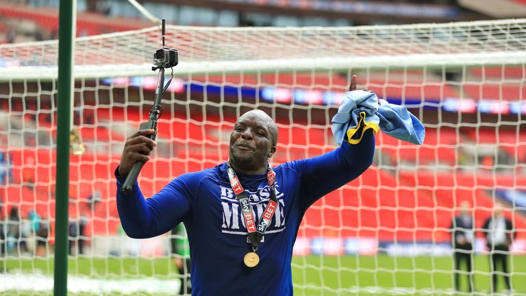 AFC Wimbledon's Adebayo Akinfenwa celebrates with a Go-Pro camera