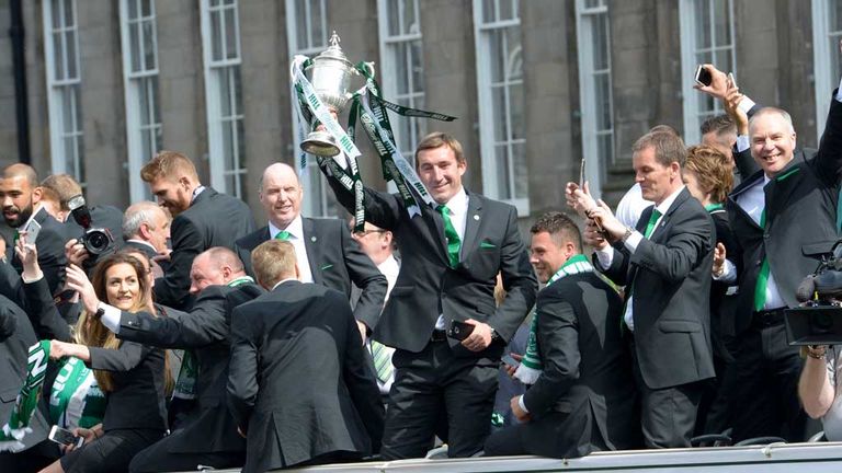 Hibernian manager Alan Stubbs (centre) holds Scottish Cup aloft as his squad embark on their victory parade through Edinburgh