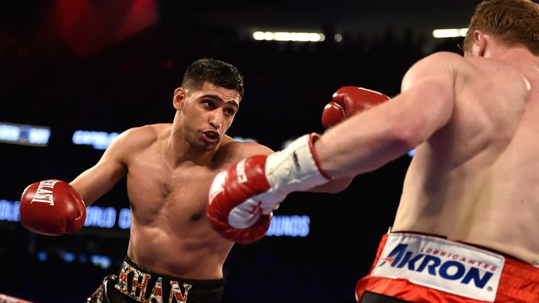 Amir Khan (L) and Canelo Alvarez battle during a WBC middleweight title fight at T-Mobile Arena