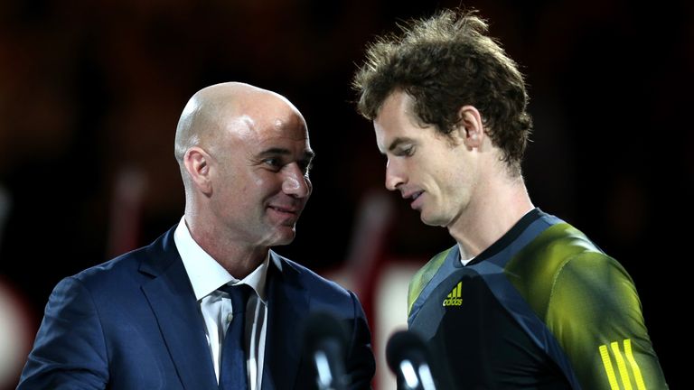 Andy Murray (R) of Great Britain speaks to Andre Agassi after losing his men's final match against Novak Djokovic of Se