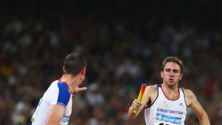 Andrew Steele of Great Britain sprints to Robert Tobin of Great Britain in the Men's 4 x 400m Relay 