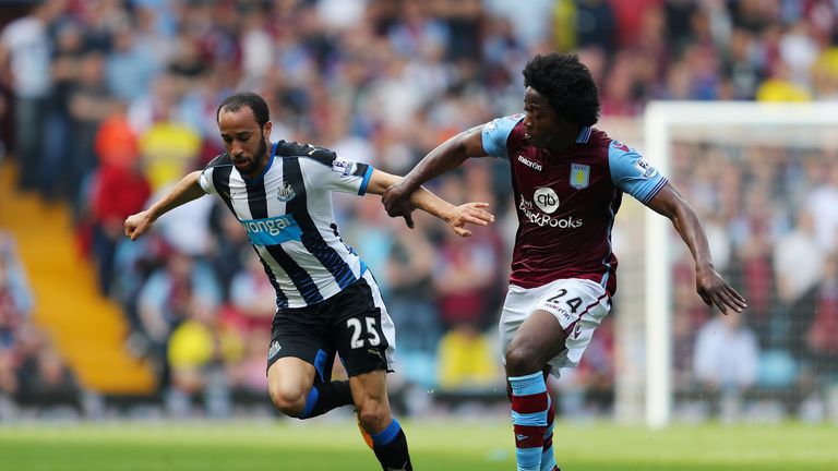 Andros Townsend of Newcastle United and Carlos Sanchez of Aston Villa compete for the ball 