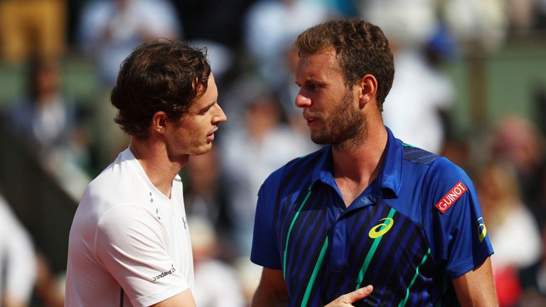 Andy Murray consoles the defeated Mathias Bourgue at the net following their second round French Open match