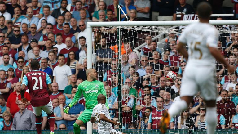 West Ham United's Angelo Ogbonna (L) can only watch as Swansea City's Andre Ayew (C) sscores