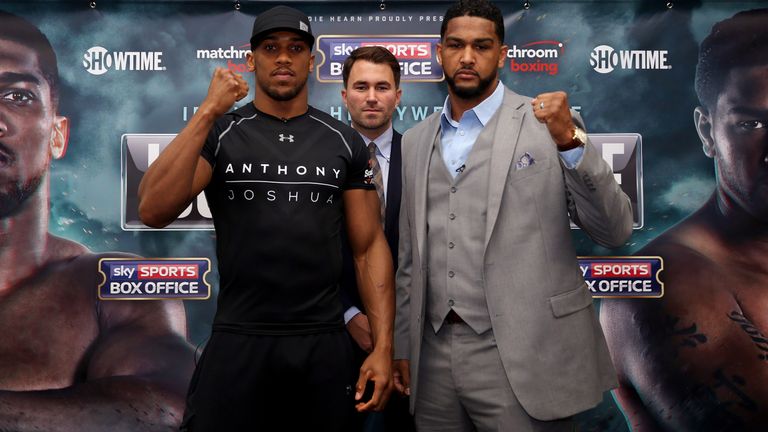 Anthony Joshua and Dominic Breazeale poses for a head to head with boxing promoter Eddie Hearn after the press conference at Hilton Syon Park, London