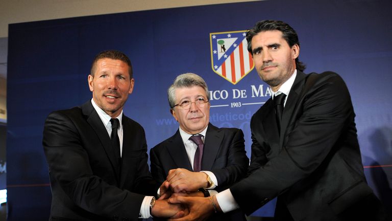 Atletico Madrid's new coach Diego Simeone pose with the club's president Enrique Cerezo and sports manager Jose Luis Perez Caminero in December 2011