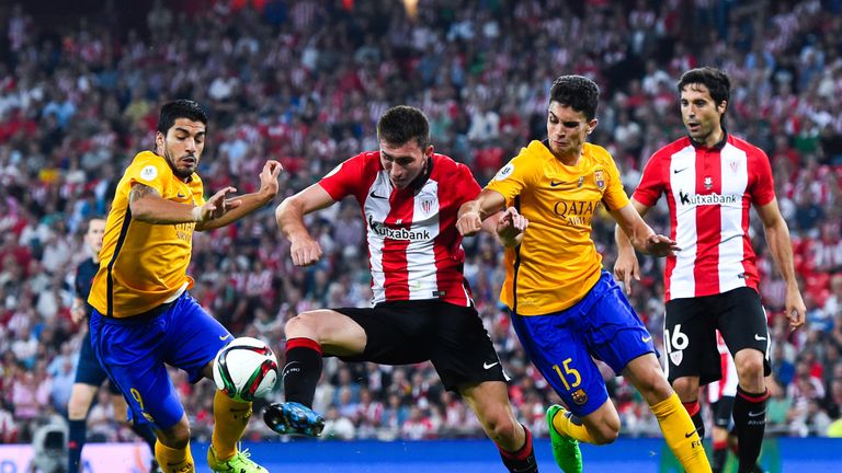 Laporte battles for the ball with Barcelona's Luis Suarez and Marc Bartra