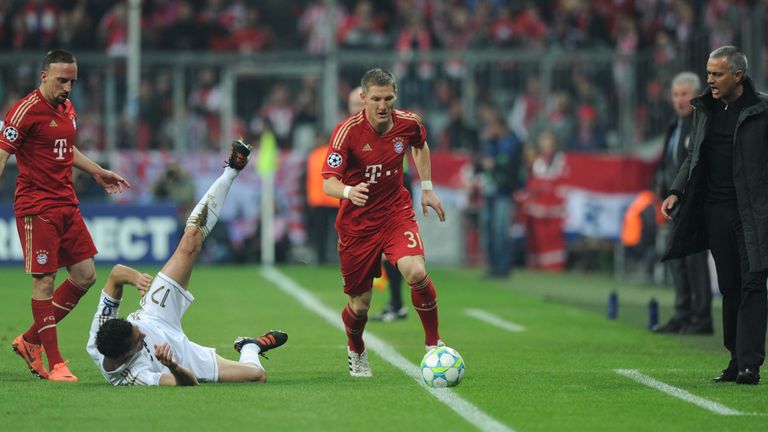 Bayern Munich's midfielder Bastian Schweinsteiger (with ball) and Jose Mourinho (right)