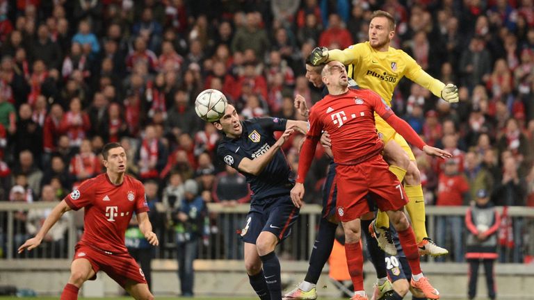 Atletico Madrid's Slovenian goalkeeper Jan Oblak gets to the ball ahead of Bayern Munich's Franck Ribery
