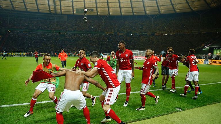 Bayern Munich's players celebrate after defeating Dortmund in the penalty shootout