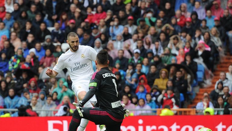 Karim Benzema of Real Madrid beats Diego Alves of Valencia CF to score his team's 2nd goal during the La Liga match 
