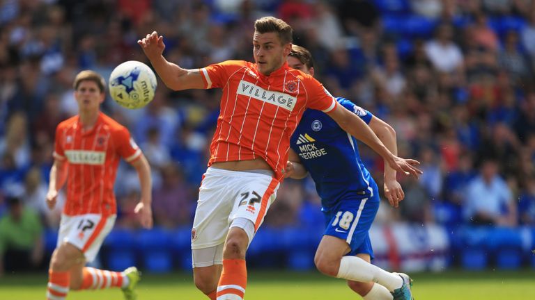  Jacob Blyth of Blackpool clears the ball from Andrew Fox of Peterborough United during the Sky Bet League One match betwee