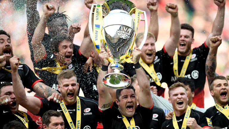 Saracens' Brad Barritt lifts the Aviva Premiership after victory over Exeter Chiefs