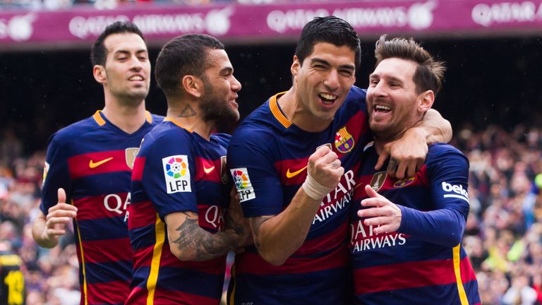 Sergio Busquets, Dani Alves and Luis Suarez celebrate with their teammate Lionel Messi after scoring the opening goal against Espanyol