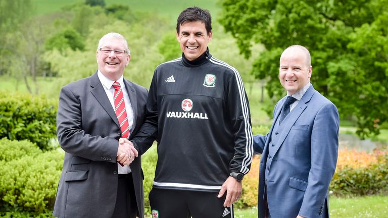 Wales manager Chris Coleman shakes hands with Football Association Wales president David Griffiths (left) and FAW chief executive Jonathan Ford