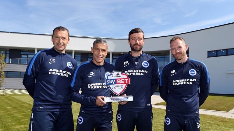 Chris Hughton celebrates his Sky Bet Championship Manager of the Month award with his staff