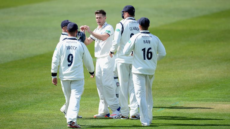 Chris Woakes of Warwickshire celebrates with teammates after dismissing Jack Leaning of Yorkshire