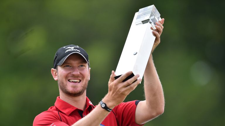 England's Chris Wood celebrates with the trophy after winning the BMW PGA Championship at Wentworth