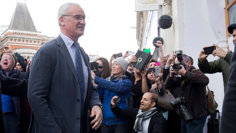 Leicester City's Italian football manager Claudio Ranieri (L) is cheered by crowds of waiting fans as he arrives for lunch at an Italian restaurant in the 