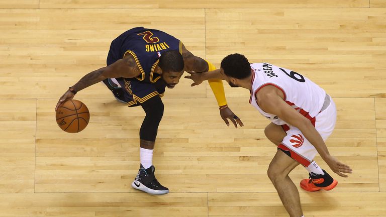 Cory Joseph #6 of the Toronto Raptors guards Kyrie Irving #2 of the Cleveland Cavaliers in Game Three of the Eastern Conference 