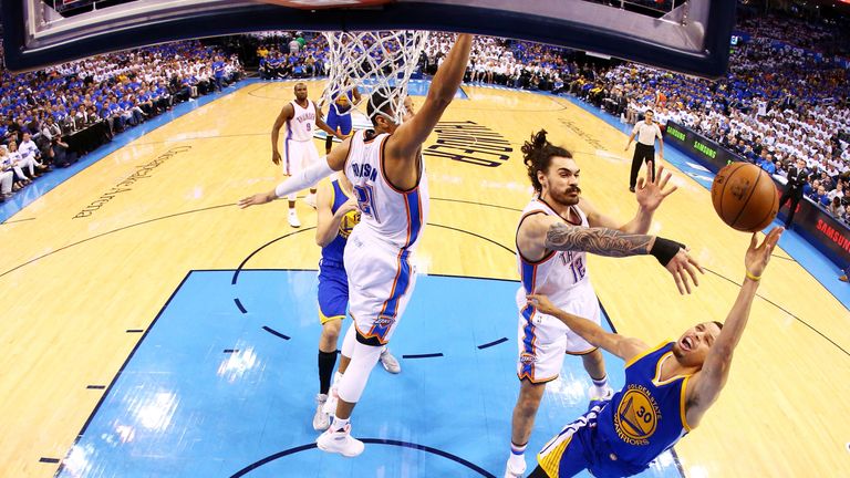 Stephen Curry #30 of the Golden State Warriors goes up against Steven Adams #12 of the Oklahoma City Thunder in game three of 
