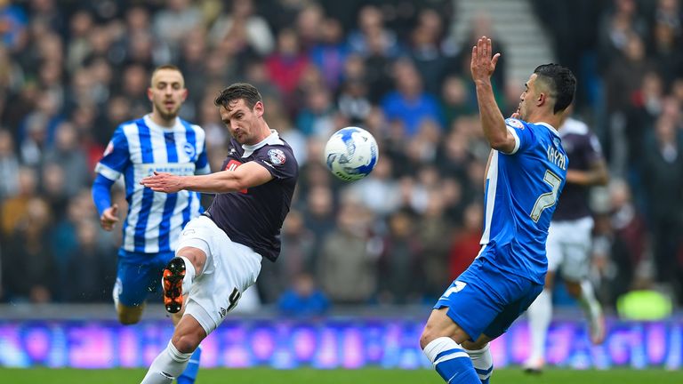 Derby's Craig Bryson clears the ball under pressure from Biram Kayal of Brighton