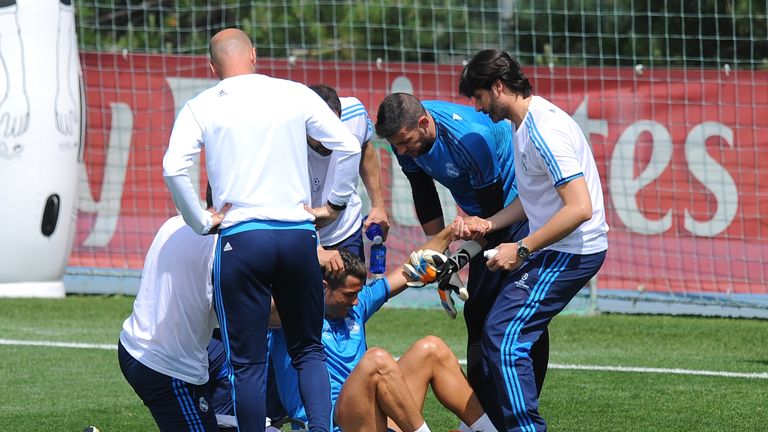 Cristiano Ronaldo of Real Madrid is helped after getting injured in the team training session during the Real Madrid Open Media Day