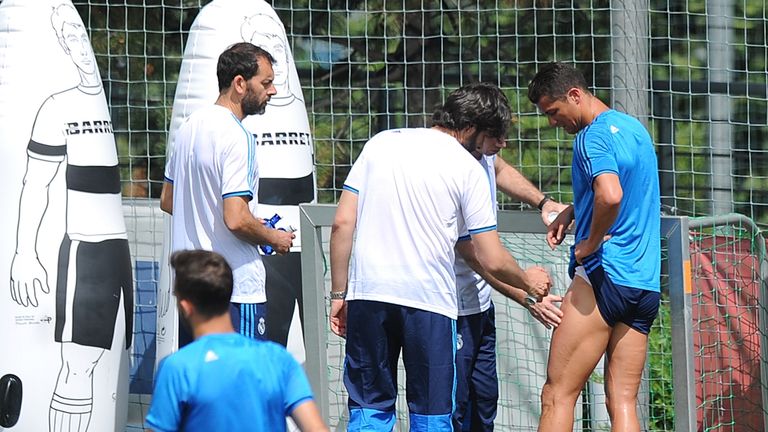 Cristiano Ronaldo of Real Madrid is helped after getting injured in the team training session during the Real Madrid Open Media Day